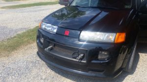 New headlight on vehicle's right (passenger side), old one on left (driver) side.